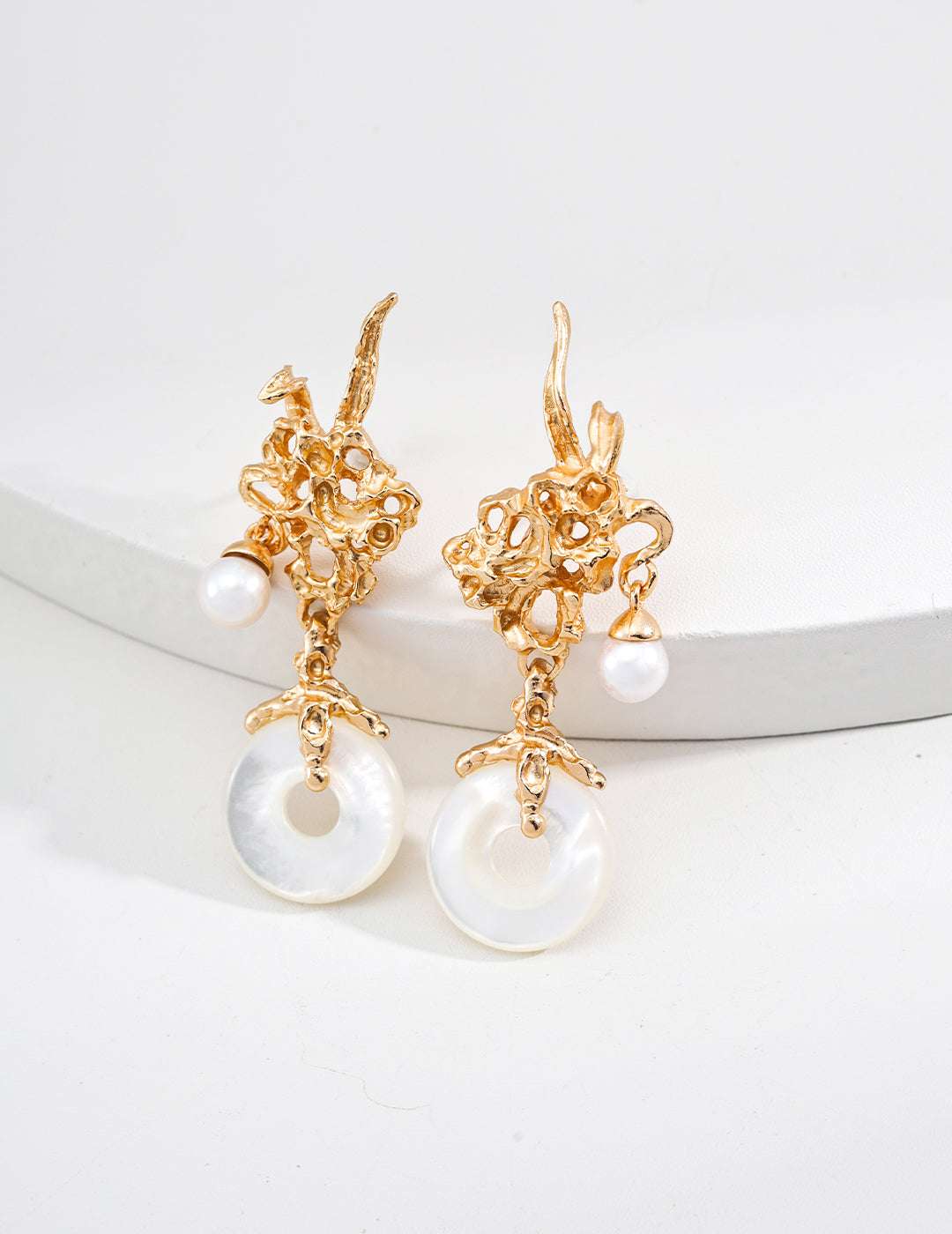 Baroque Aurora — pair of earrings on neutral background showing antique‑gold accents