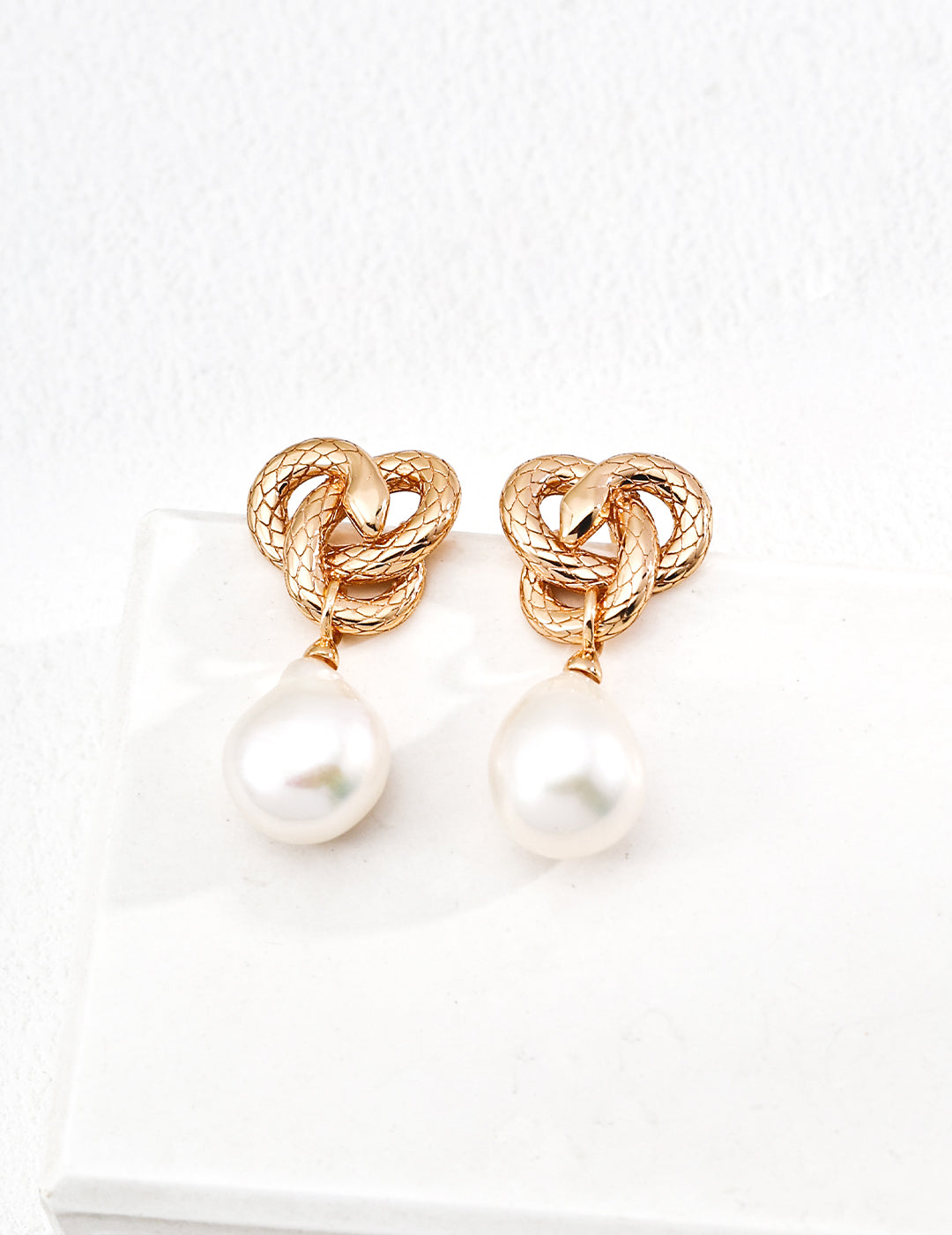 Ophic Baroque Luster — oxidized silver serpent coil earring cradling a natural baroque pearl, close‑up｜Forya J'adore